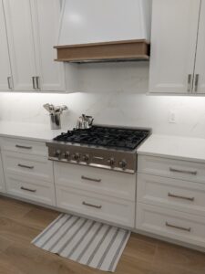 "Full kitchen renovation with tile, cabinets, and flooring by Paul’s Masterpiece Tile."